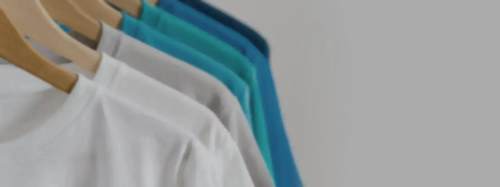 Blank tee shirts hanging on a rack